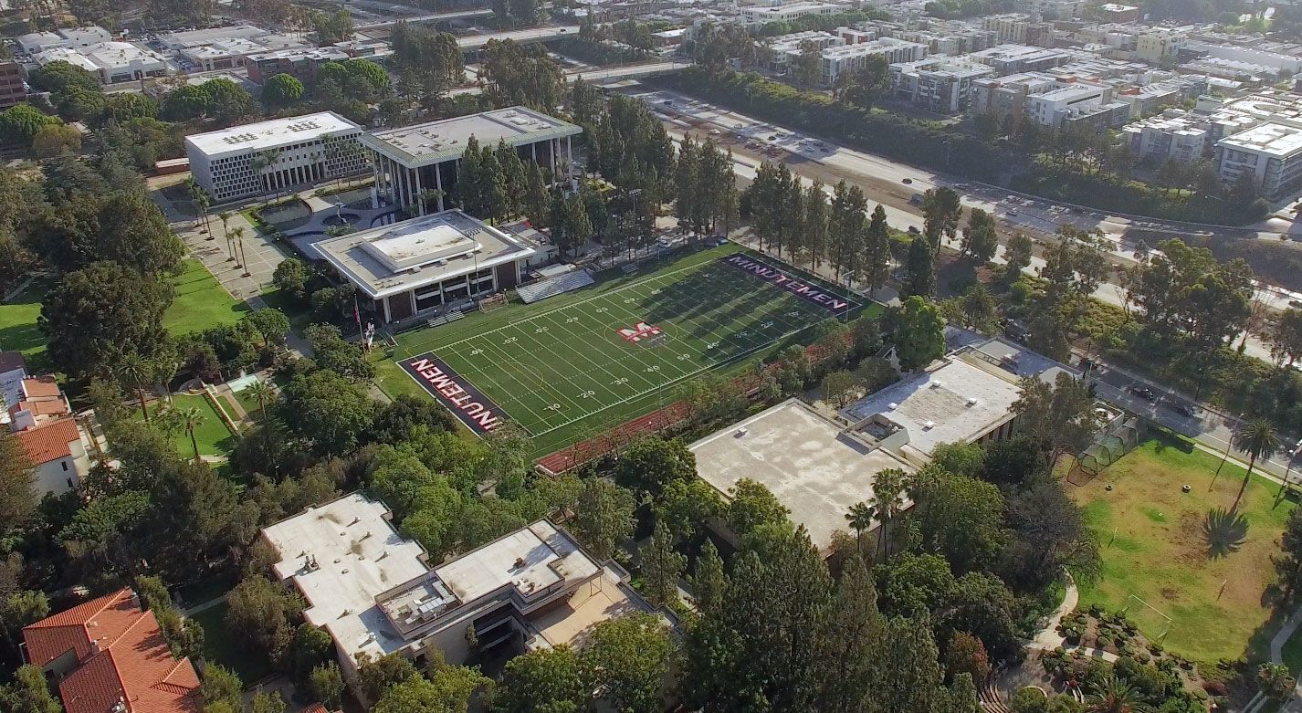 Image of 2 retro cars in a driveway of a Palm Springs house
